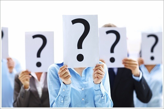 Business people standing with question mark on boards